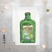Load image into Gallery viewer, Green bottle with 'Prince of Potions' label on a white card against a textured gray background.