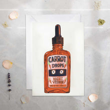 Load image into Gallery viewer, Greeting card with a bottle of 'Carrot Drops Night Vision' on a textured surface.
